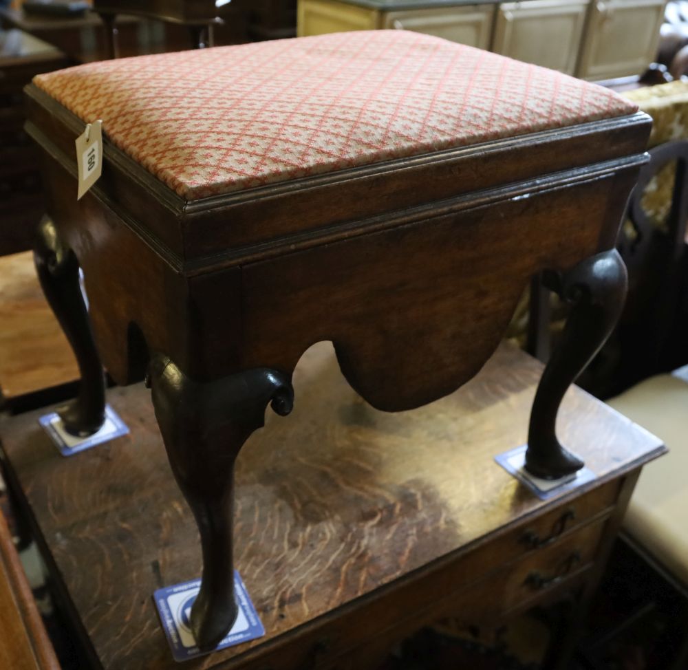 A George III mahogany box stool, the hinged lid with upholstered top above shaped apron and cabriole knees, on pointed pad feet, width